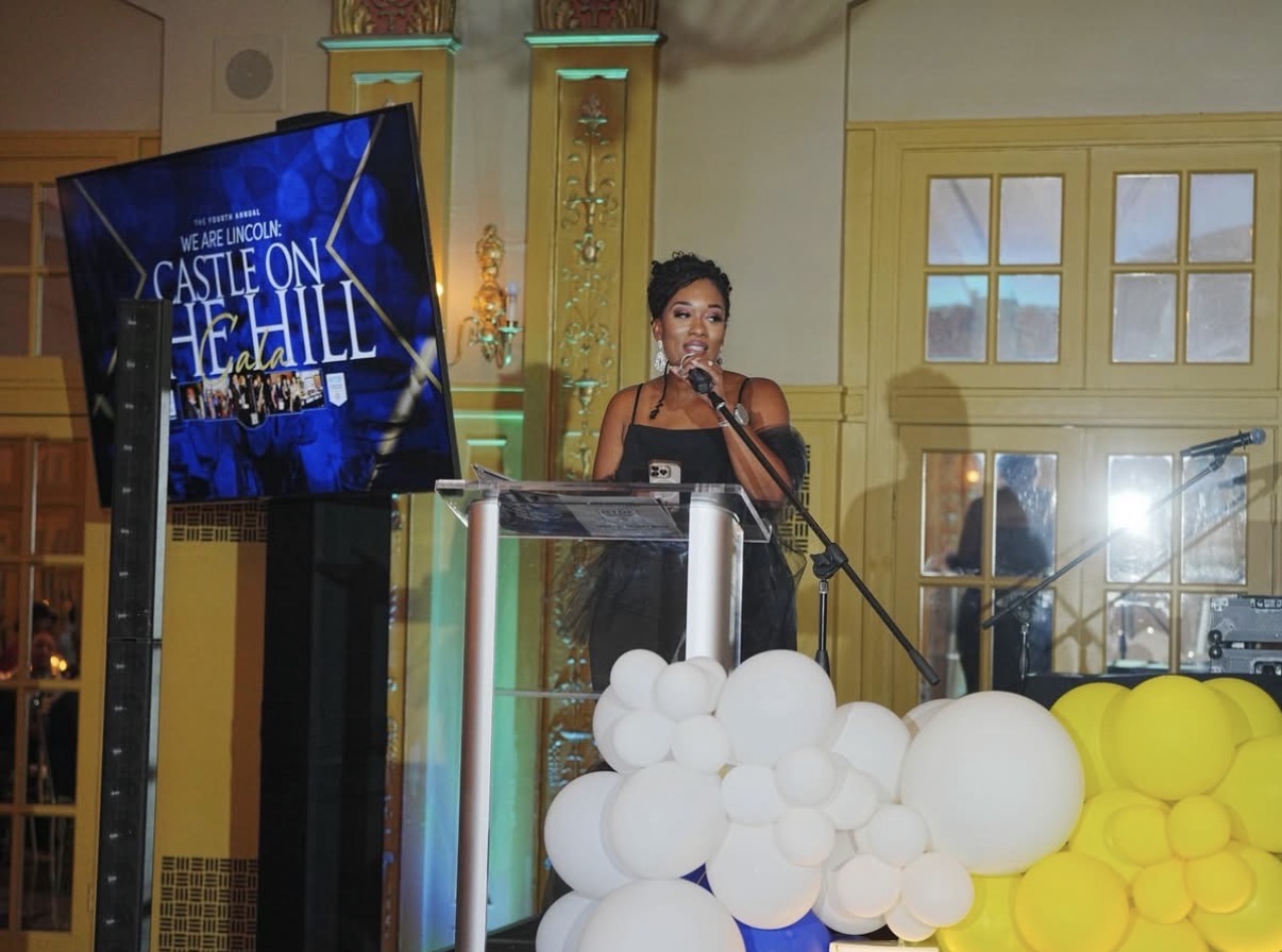 Kelli Turner speaking at a gala event